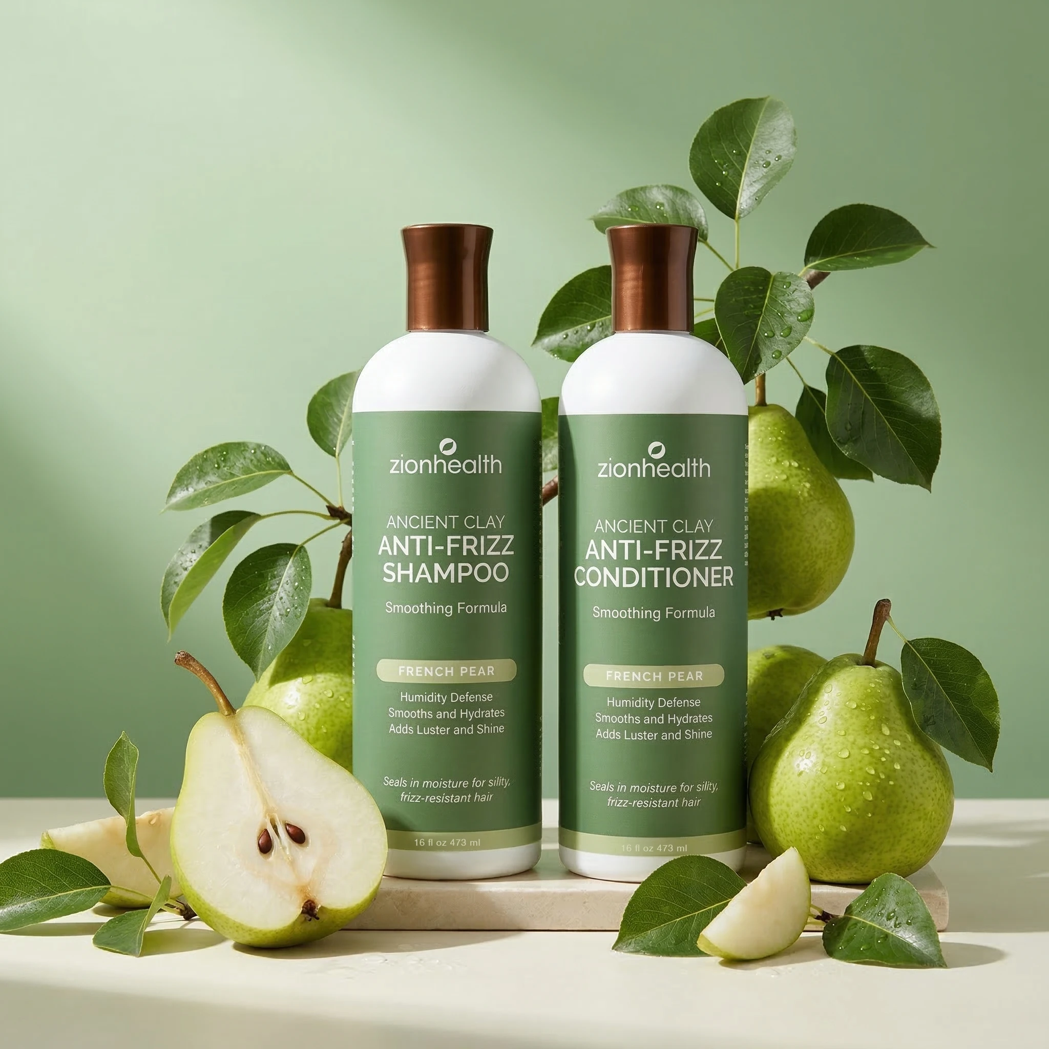 Zion Health Ancient Clay Anti-Frizz Shampoo and Conditioner bottles displayed with fresh green pears and leaves on a soft green background.