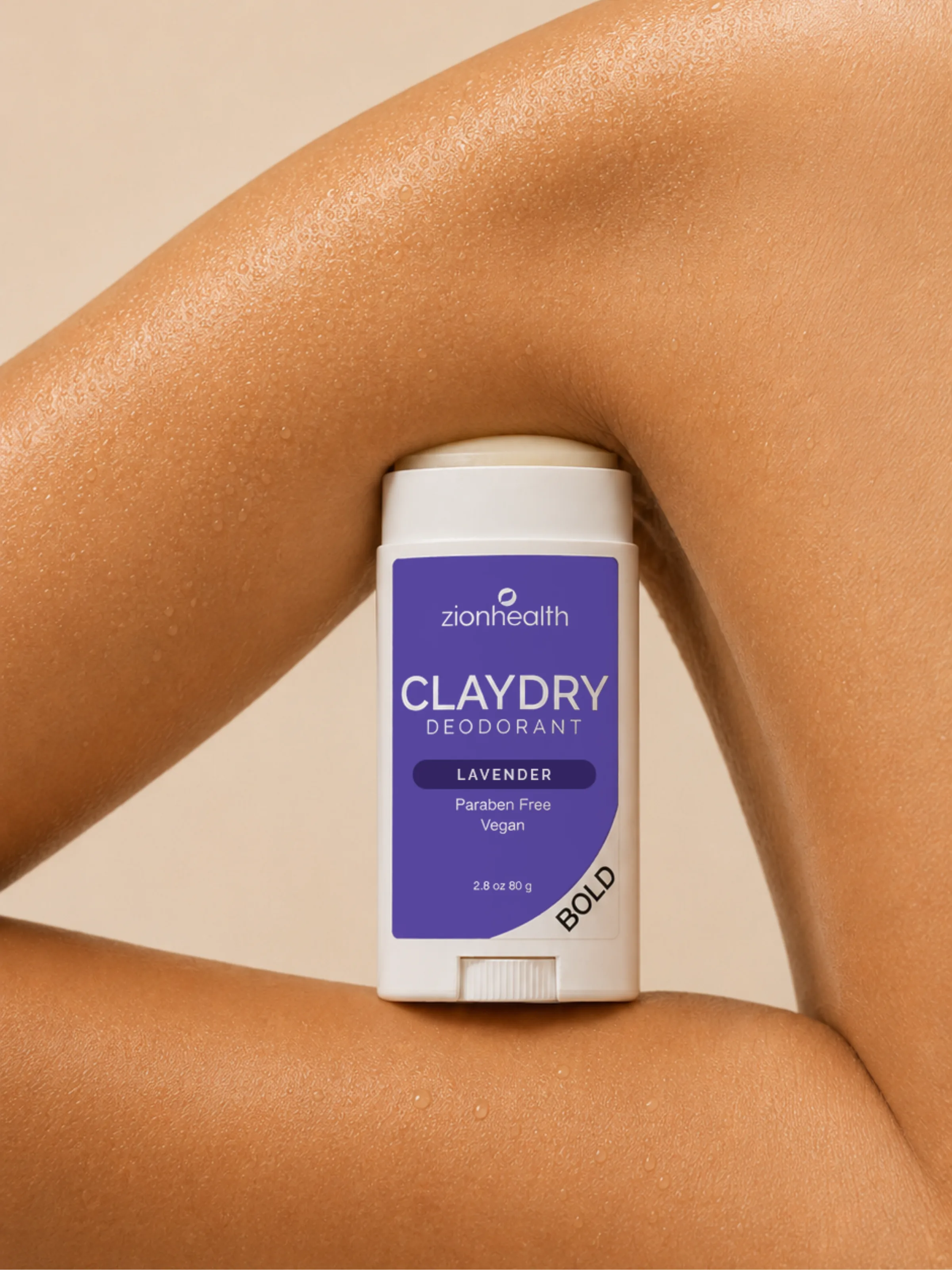 Zion Health Claydry Deodorant Lavender Bold held against tanned, sun-warmed skin.