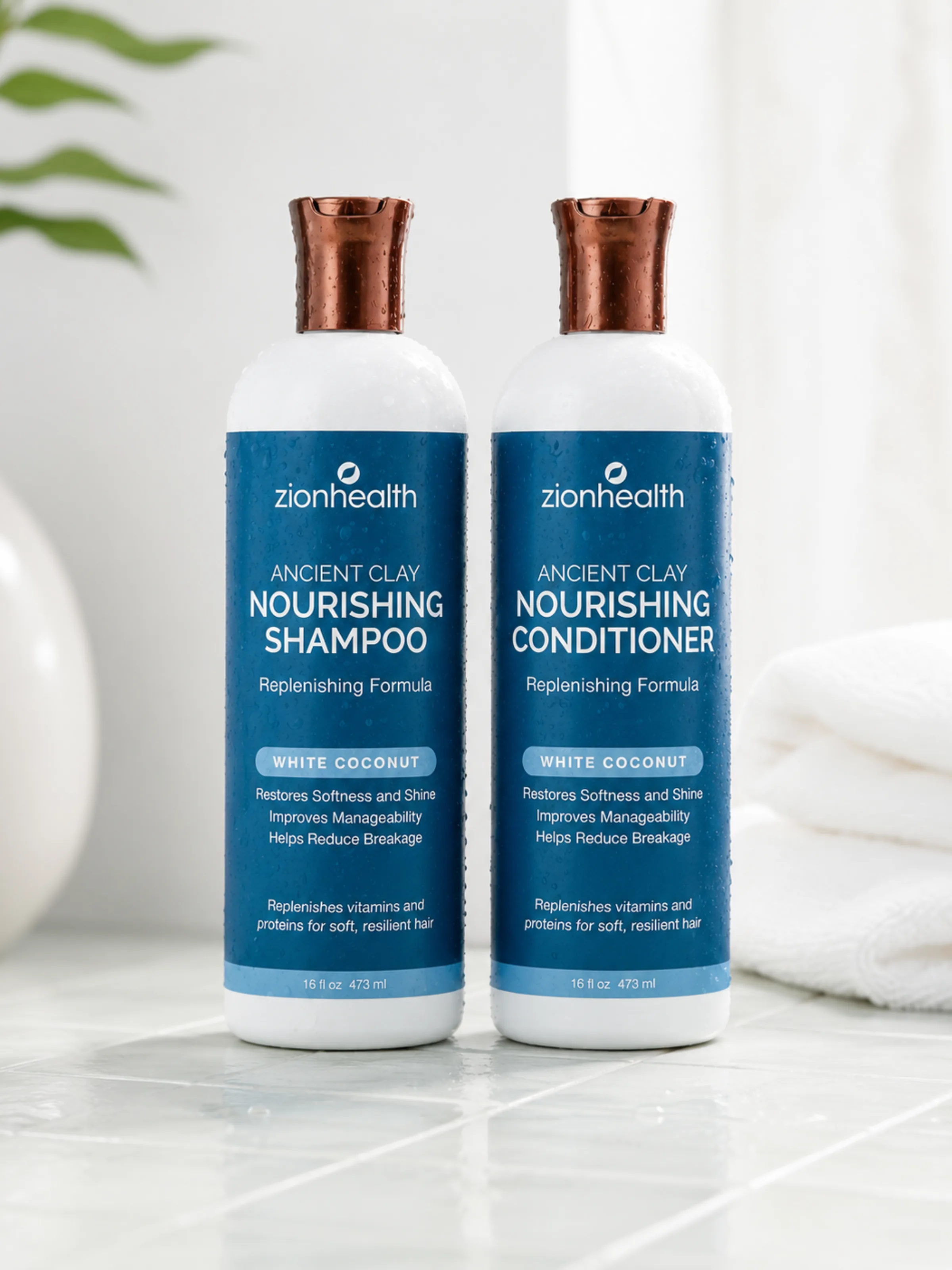 Two bottles of Zion Health Ancient Clay Nourishing Shampoo and Conditioner in White Coconut, styled on bathroom tile.