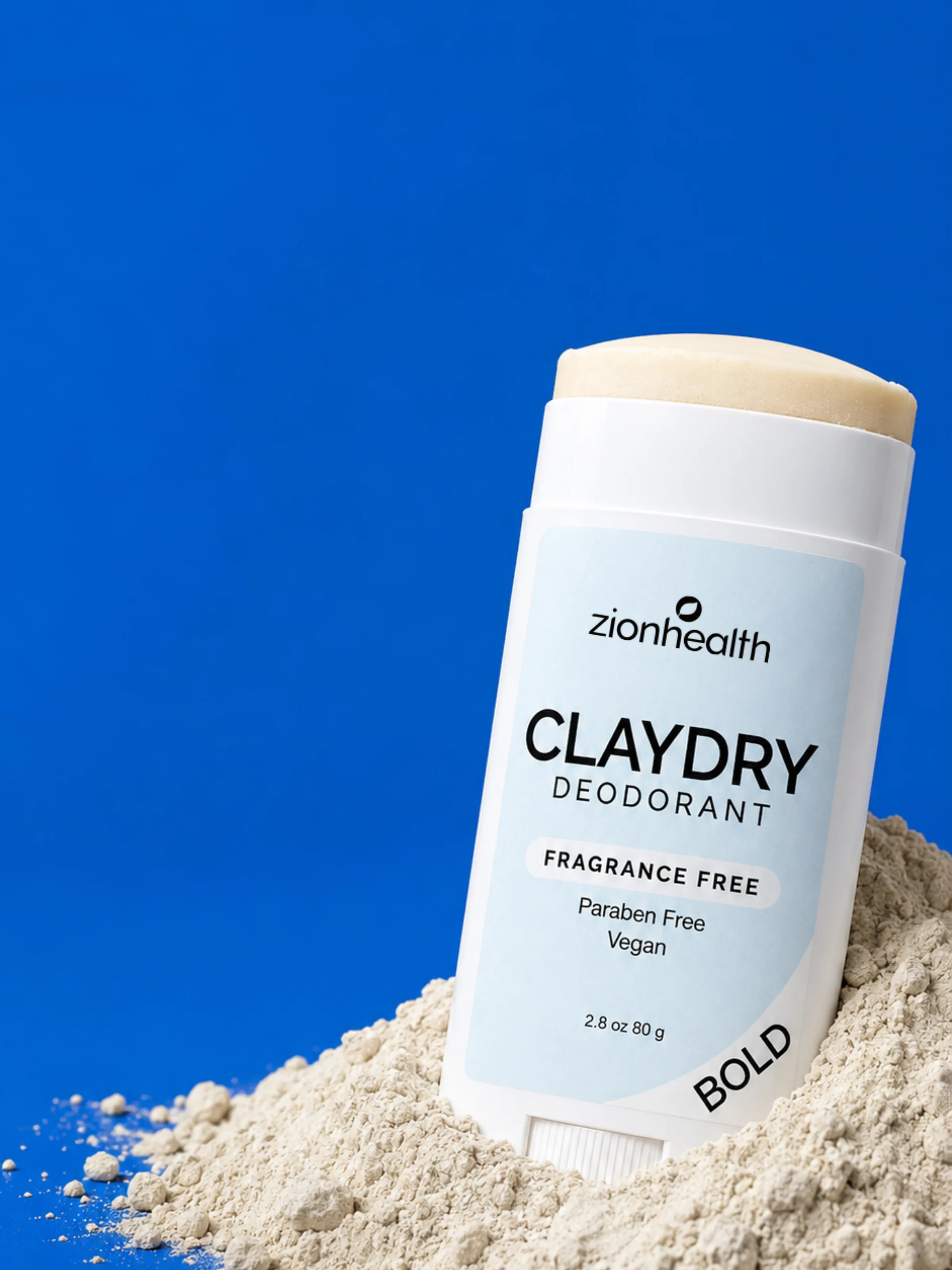 Zion Health Claydry Deodorant Fragrance Free Bold standing in a mound of clay powder against a blue background.