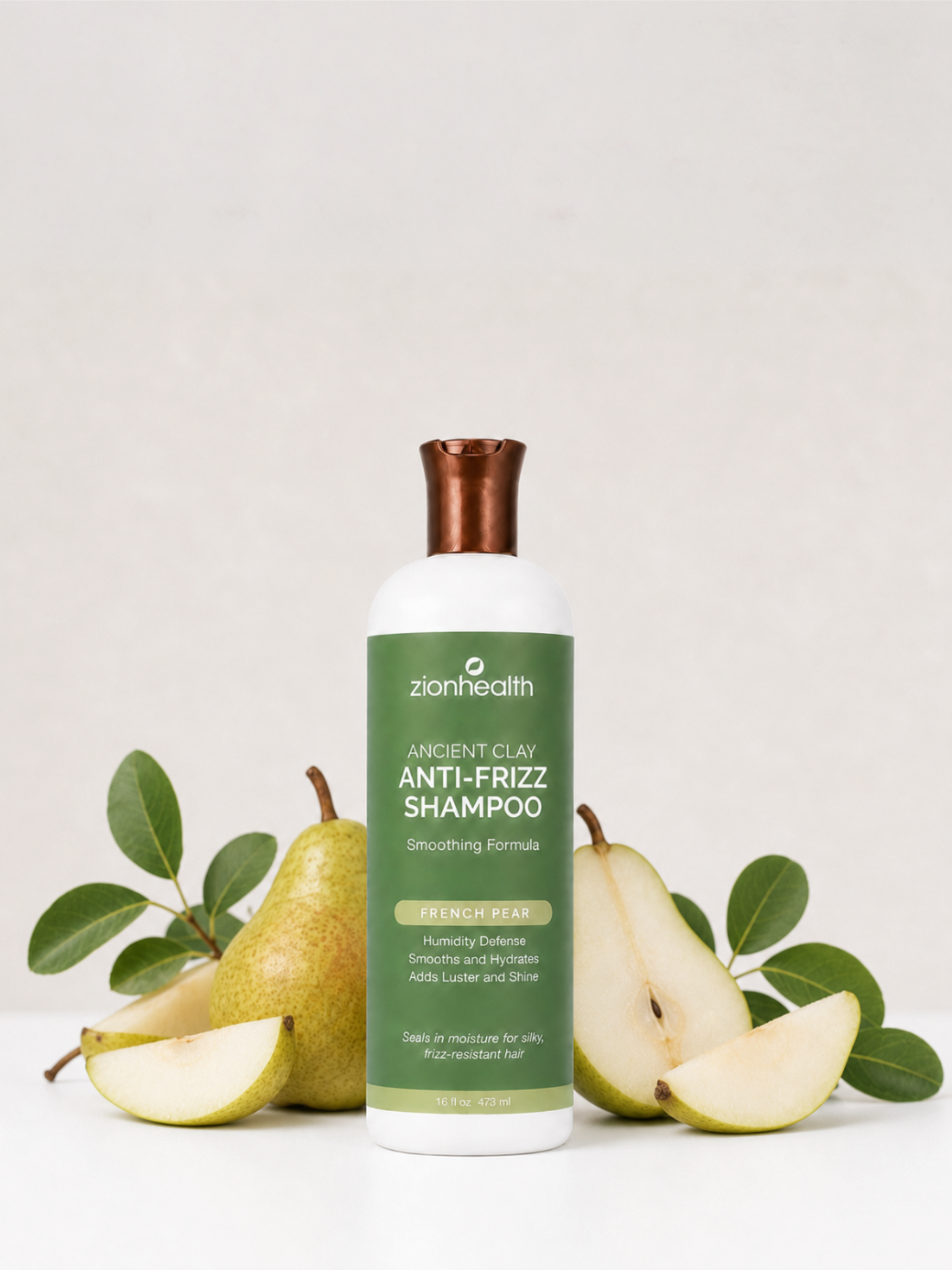 Zion Health Ancient Clay Anti-Frizz Shampoo in French Pear, styled with fresh pears and leaves.